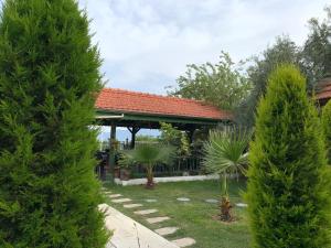a house with a gazebo in a garden at Pınar Vintage House in Pamukkale