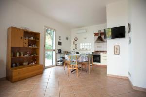 a kitchen with a table and a dining room at Villa Nadia con splendida vista mare in Castellammare del Golfo