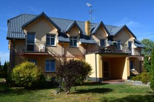 a large house with a black roof at U Rybaka (pokoje) in Jezierzany