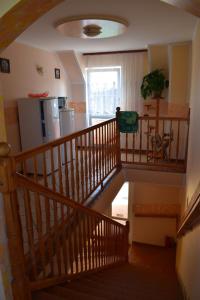 a wooden staircase in a kitchen with a refrigerator at U Rybaka (pokoje) in Jezierzany