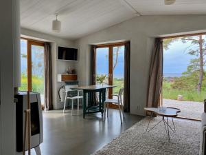 a living room with a table and chairs and windows at Kruthuset in Visby