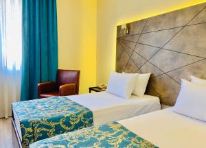 En eller flere senge i et værelse på Hostapark Hotel