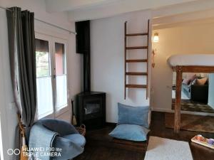 a living room with a bunk bed and a fireplace at Casa Rosa Garden House in Santa Cristina d'Aro