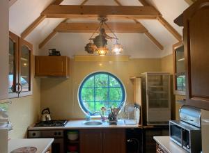 a kitchen with a sink and a large window at U Krzysztofa in Kopalino
