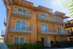 an orange building with balconies on the side of it at Residence Desiree in Riva del Garda