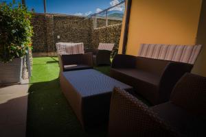 a group of chairs and tables in a patio at Residence Desiree in Riva del Garda