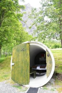 a round trailer with a bed in the middle at Campingplatz mit Restaurant & Sportarena Leukerbad in Leukerbad