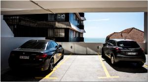 
a car parked on the side of a road next to a building at DeptosVip - Gascón in Mar del Plata
