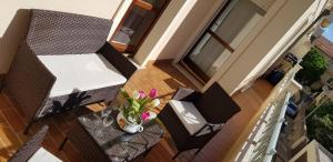 an overhead view of a balcony with chairs and a table at Alghero Heart in Alghero