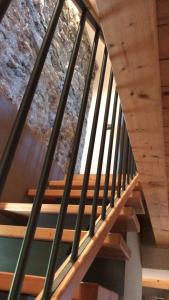 a wooden staircase in a house with a wooden ceiling at La Locanda dei Cavalieri in Mormanno