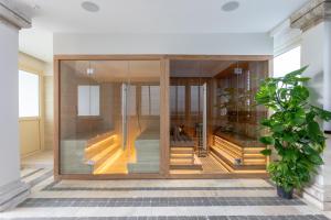 a room with glass doors and a potted plant at Porto Romano - The Marina Resort in Fiumicino