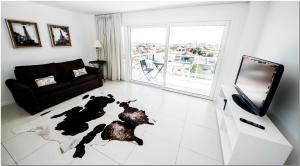 a living room with a dog laying on the floor at DeptosVip - Rivas in Mar del Plata