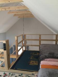 a bedroom with a bunk bed and a ladder at Marzeniec w Beskidzie Niskim in Wapienne