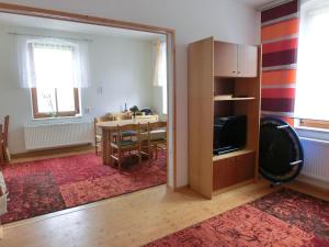 a living room with a dining room table and a television at FeWo zwischen Augustusburg und Freiberg in Eppendorf