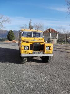 
a yellow school bus parked in a parking lot at Hotel Encostas De Nantes in Chaves
