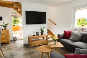 a living room with a couch and a flat screen tv at Haus Wulveshagen in Langelsheim