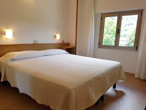 Voodi või voodid majutusasutuse Albergo Miralaghi toas