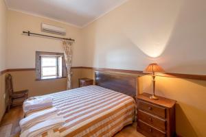 Postel nebo postele na pokoji v ubytování Quinta Sta Luzia Carrascal