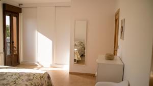 a bedroom with a bed and a mirror at Apartamentos Casa Cabana in Cambados