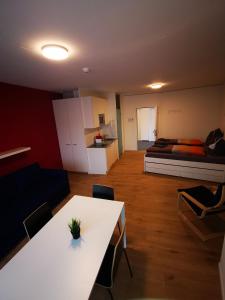 Cette chambre comprend une table blanche et un lit. dans l'établissement Anstatthotel Horw - self-check-in, à Lucerne