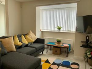 a living room with a couch and a table at City Bridge Townhouse 4 in Newcastle upon Tyne