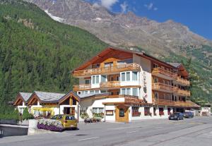 a large building in front of a mountain at Eden in Saas-Grund
