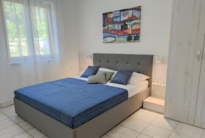 a bedroom with a bed with a blue comforter at Apartments Riba in Vis