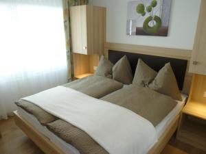 a bedroom with a large bed with white sheets at Eden in Saas-Grund