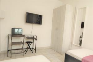 a room with a table and a tv on the wall at Apartments Riba in Vis