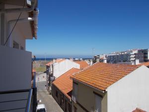 an overhead view of roofs of buildings and the ocean at Abrigo do Portinho in Vila Praia de Âncora