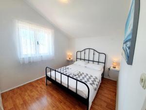 Posteľ alebo postele v izbe v ubytovaní Apartmani Mikulić