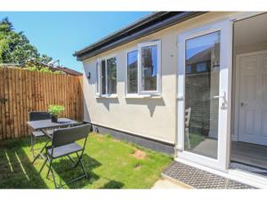 a caravan with a door and a table and chairs at StayZo - Crofton Park - Central London refurbished Studio in London