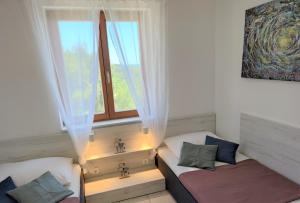 a living room with a couch and a window at Apartments Riba in Vis