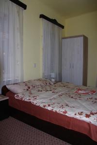 a bedroom with a bed with red flowers on it at Casa Maior 