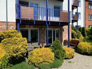 a house with a balcony on top of it at Apartament Villa Baltic - Chalupy in Chałupy