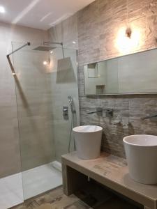 a bathroom with a sink and a glass shower at Casa Serena in Cuttoli-Corticchiato +11 photos