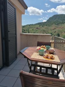 a wooden table with food on it on a balcony at Apartaments Mitjavila in Sant Salvador de Toló
