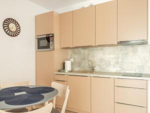 a small kitchen with a table and a microwave at Nadmorskie Tarasy a 407 in Kołobrzeg