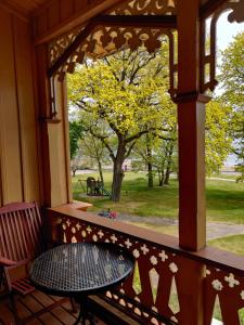 a wooden porch with a table and a window at Villa OLD POST in Juodkrantė