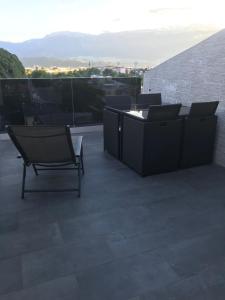 d'une terrasse sur le toit avec des chaises et des tables. dans l'établissement Apartment Mathilda, à Bolzano