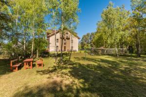 a house with a picnic table in the yard at Danusia in Dębki