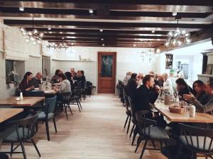 a group of people sitting at tables in a restaurant at Hotel Heiligenstein in Baden-Baden