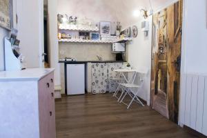 a kitchen with a counter and a table in a room at La Camera Dal Ponte in Dolceacqua