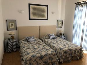 a bedroom with two beds and two lamps at Casa Camelia in Vilamoura +51 photos