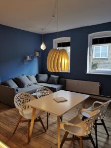 a living room with a couch and a table and chairs at Freiraum in Flensburg