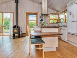 a kitchen with a table and a stove at 6 person holiday home in Ebeltoft in Femmøller