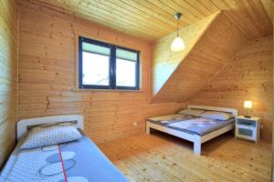 Кровать или кровати в номере Domki Letniskowe Marina