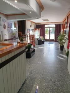 an office lobby with a counter and potted plants at Pension los Verdiales in La Herradura