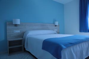 Postel nebo postele na pokoji v ubytování Hotel Las Catedrales