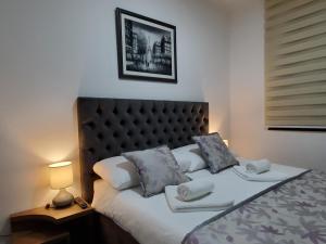 a bedroom with a bed with two pillows on it at Zlatibor Hills Royal in Zlatibor +70 photos